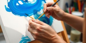 Person painting, calm, vibrant colors, flowing lines.